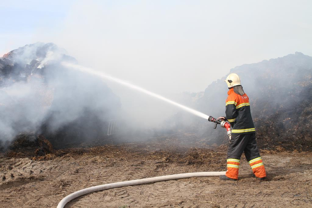 Brandvæsnet måtte søndag eftermiddag rykke ud for at slukke ild i en stabel halmballer. Foto: Morten Sundgaard - Skadestedsfotograf.dk.