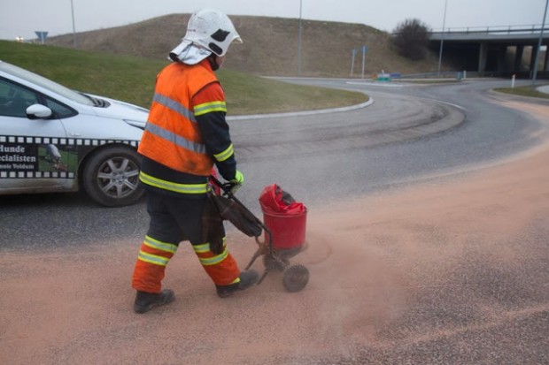Brandfolk spredte kattegrus på den spildte dieselolie. Foto: Michael Johannessen.