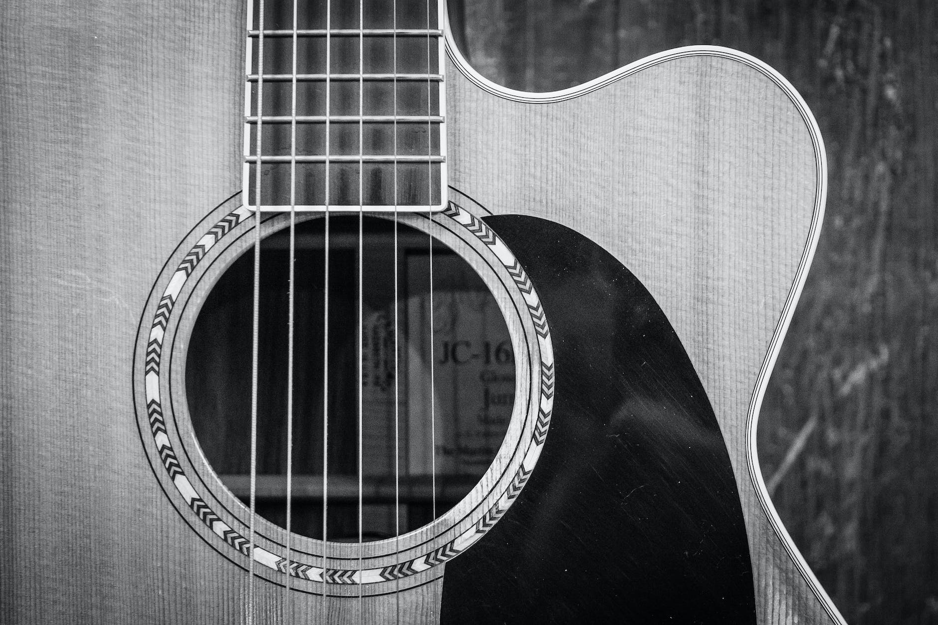grayscale photo of cutaway acoustic guitar