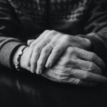 grayscale photo of a person wearing ring