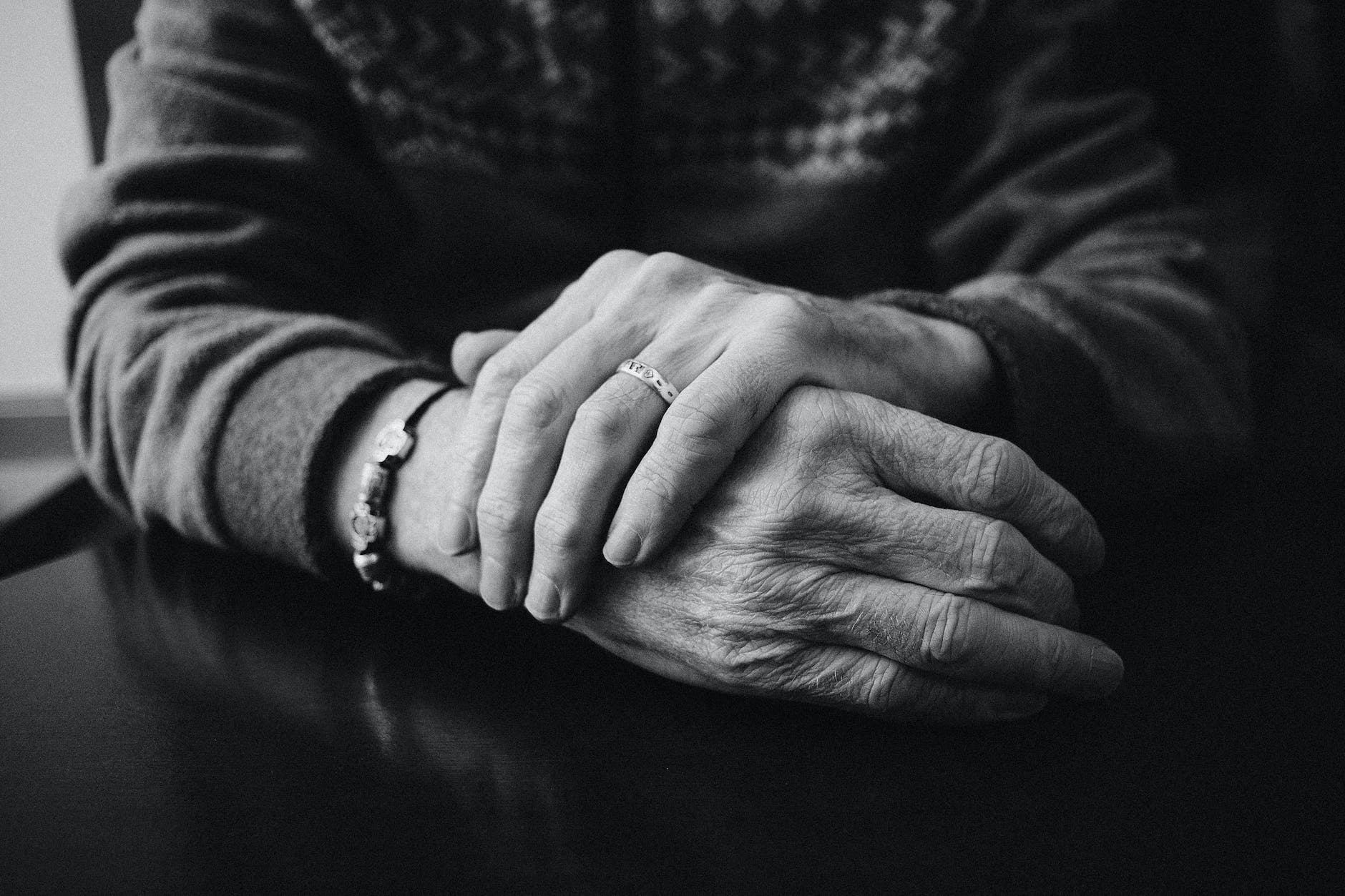 grayscale photo of a person wearing ring