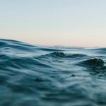 body of water under blue and white skies