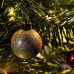 glistening christmas bauble on fir tree branch