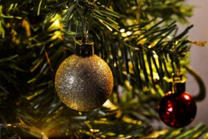 glistening christmas bauble on fir tree branch