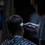 man holds black hair shaver