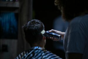 man holds black hair shaver