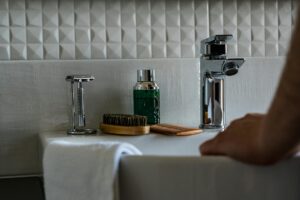 a person holding the white sink