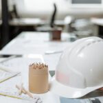 white hard hat next to a kraft paper jar