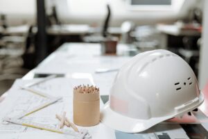 white hard hat next to a kraft paper jar