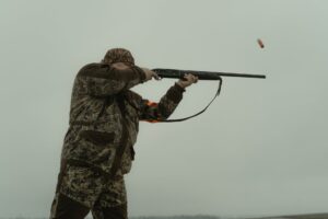 photo of a man firing his shotgun